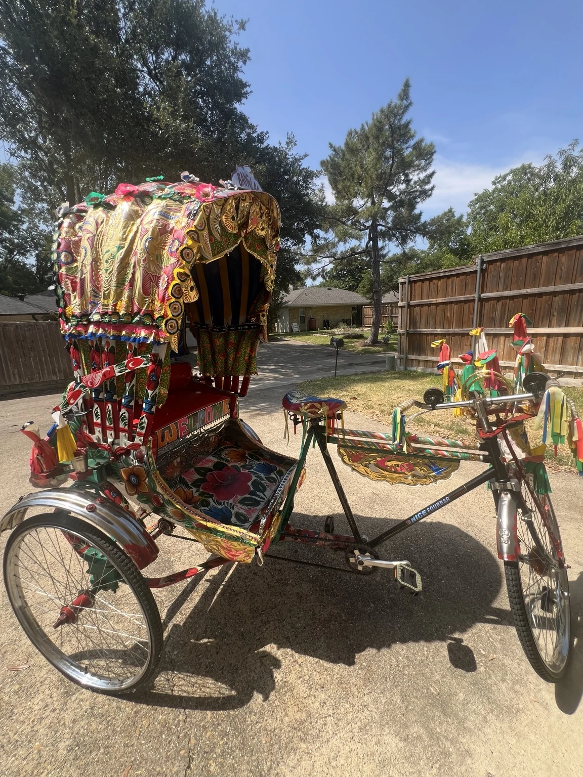 Close view of the authentic Royal Rickshaw DFW showing hand-painted floral artwork and traditional decoration