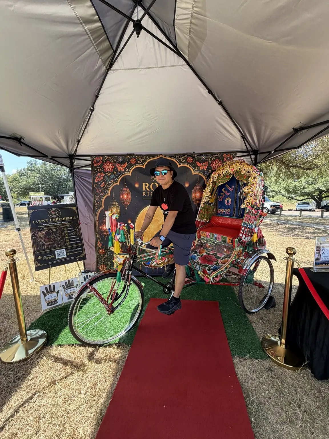 Guest posing beside the colorful Royal Rickshaw DFW bicycle