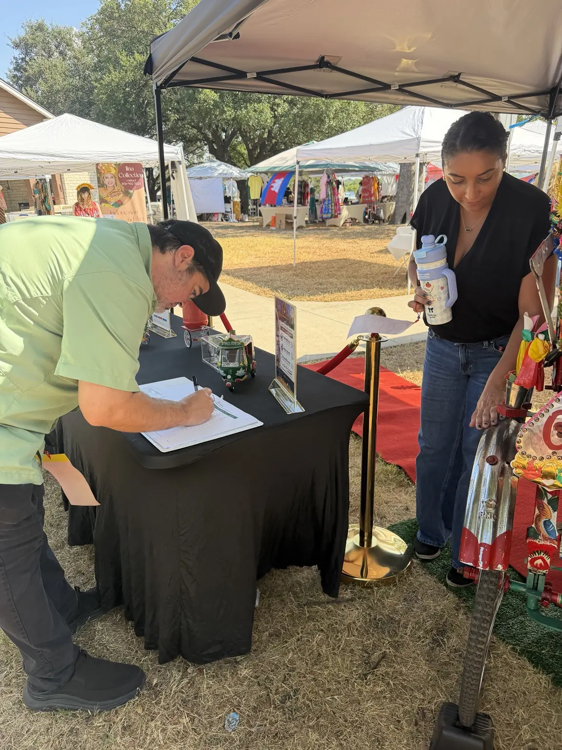 Festival guest signing in at the Royal Rickshaw DFW welcome table