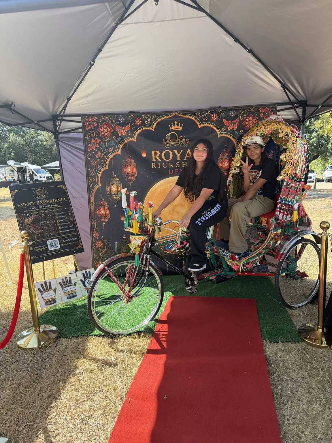 Festival guests seated inside the Royal Rickshaw DFW display