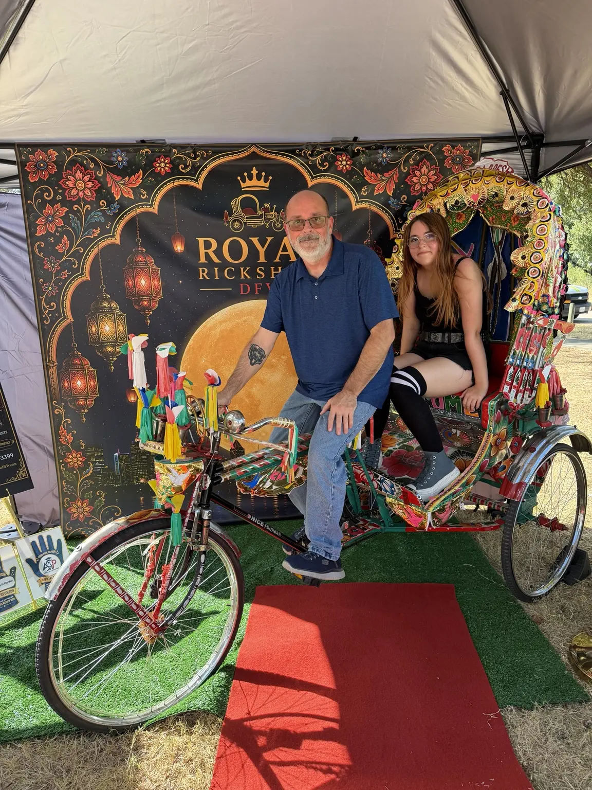 Family smiling for a portrait inside the Royal Rickshaw DFW booth