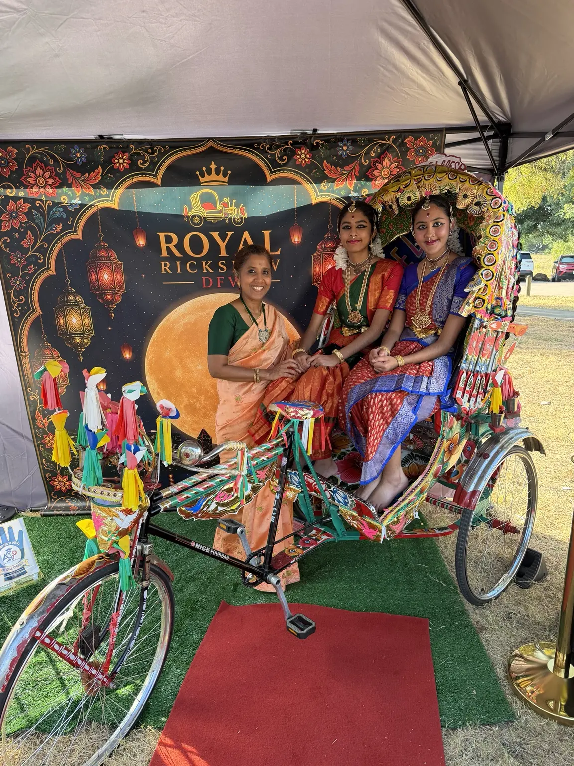 Three generations sharing a cultural photo moment in the Royal Rickshaw