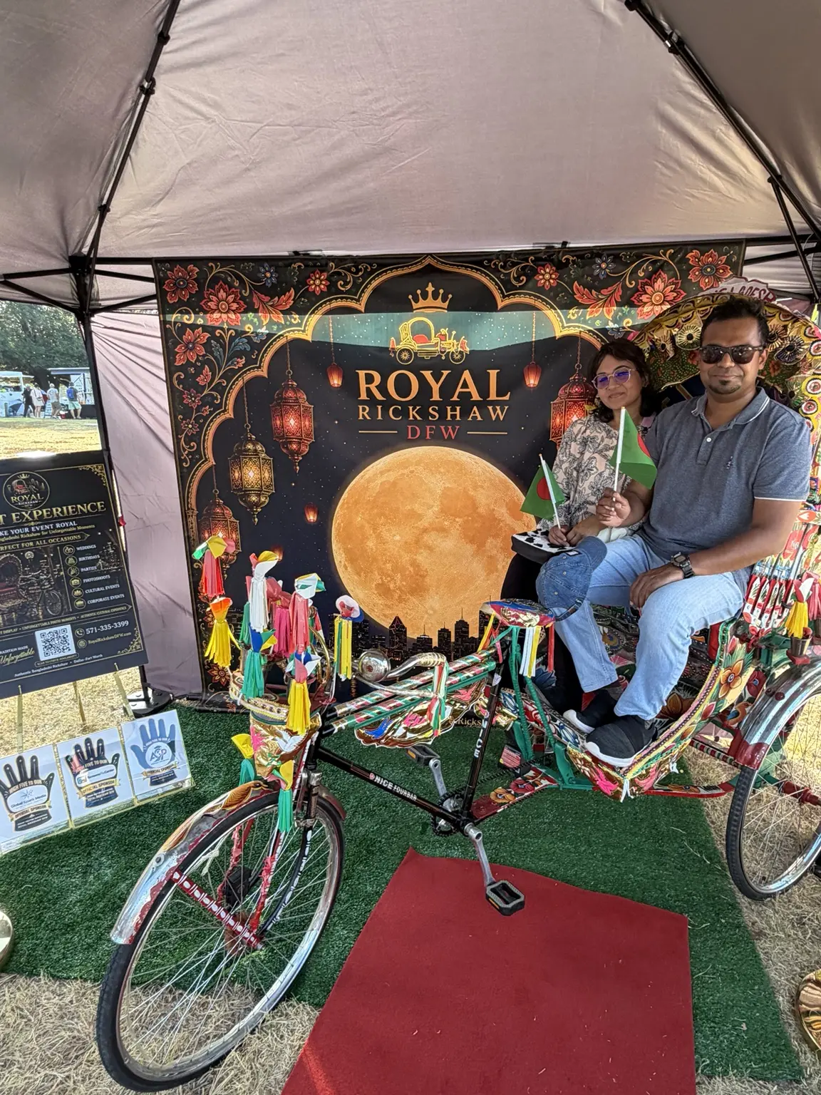 Adult and child seated together inside the Royal Rickshaw DFW display