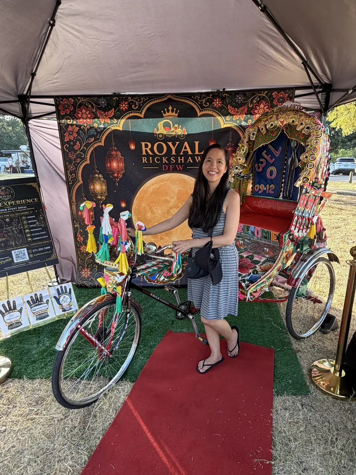 Festival guest posing beside the decorated authentic Bangladeshi rickshaw