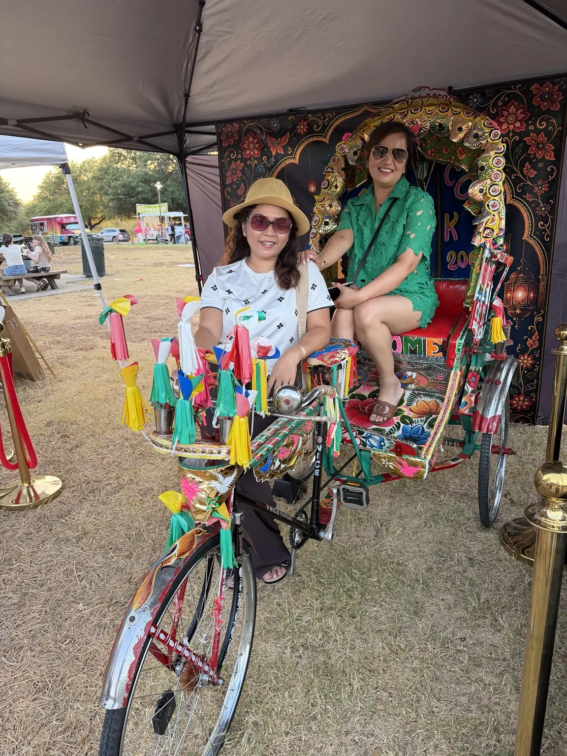 Festival guests smiling together inside the Royal Rickshaw DFW booth