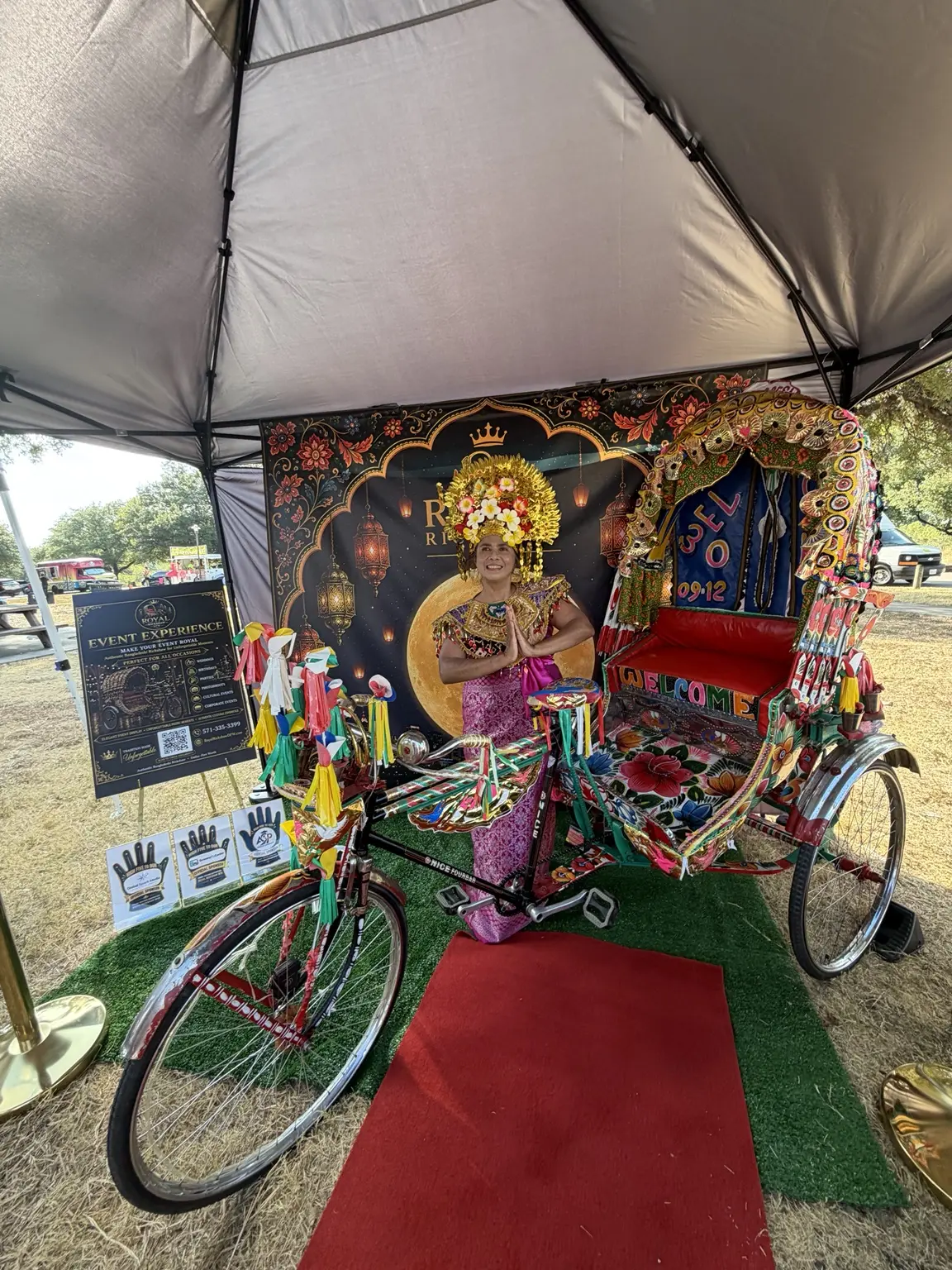 Crowned festival participant posing with the Royal Rickshaw DFW display