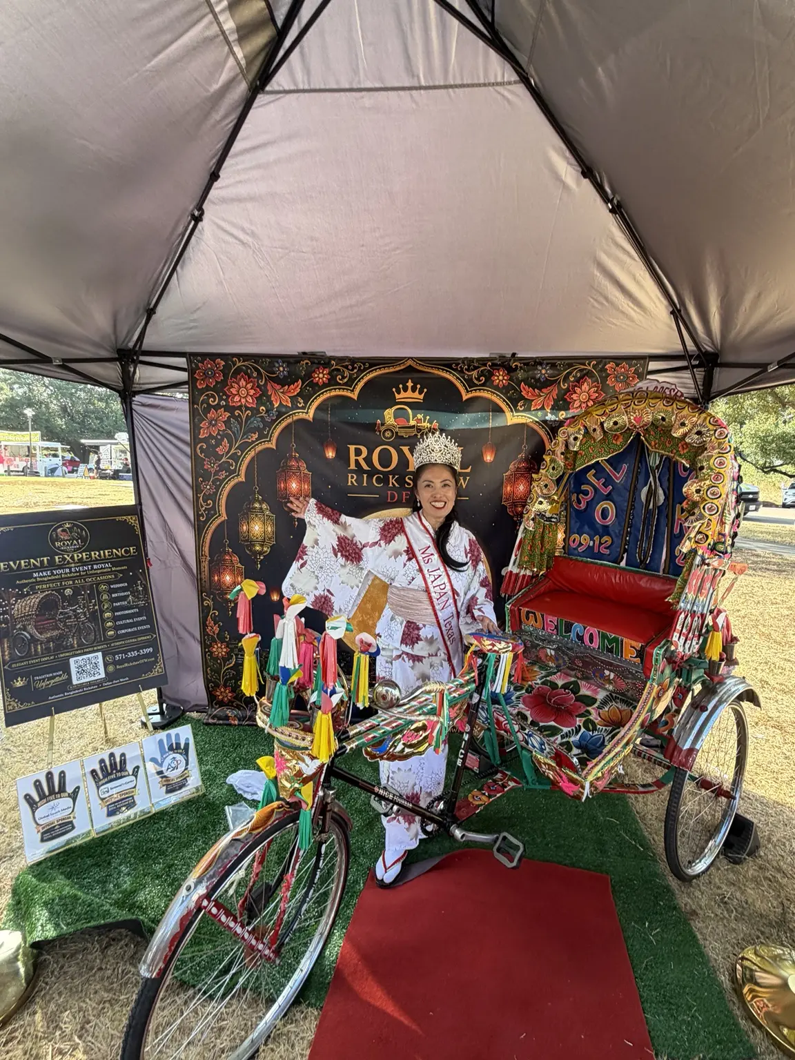 Young cultural performer seated in the decorated Bangladeshi rickshaw