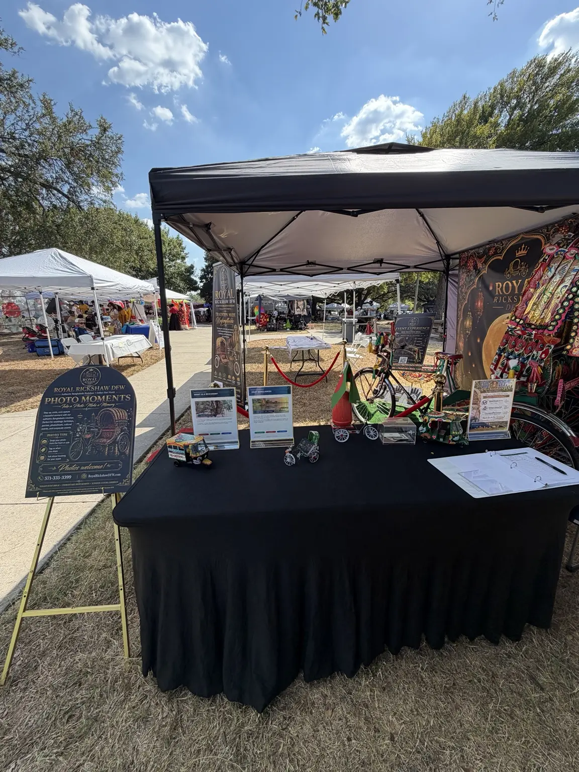 Front view of the Royal Rickshaw DFW welcome table and cultural booth