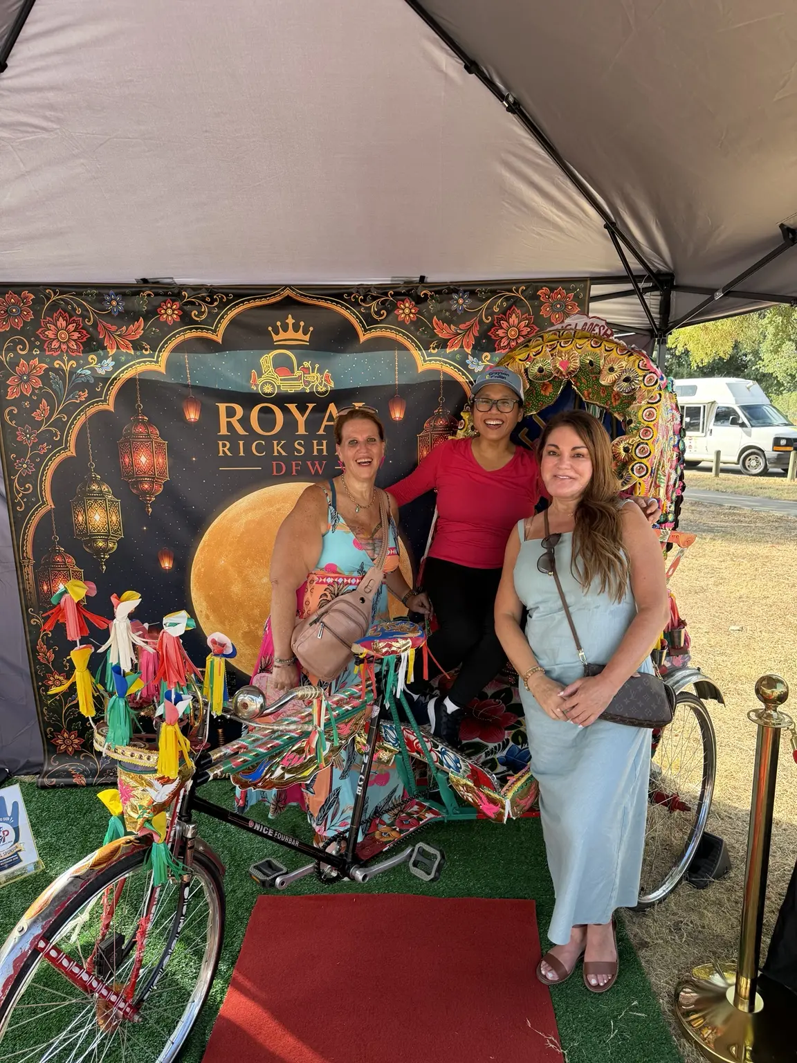 Family group smiling together around the decorated Royal Rickshaw