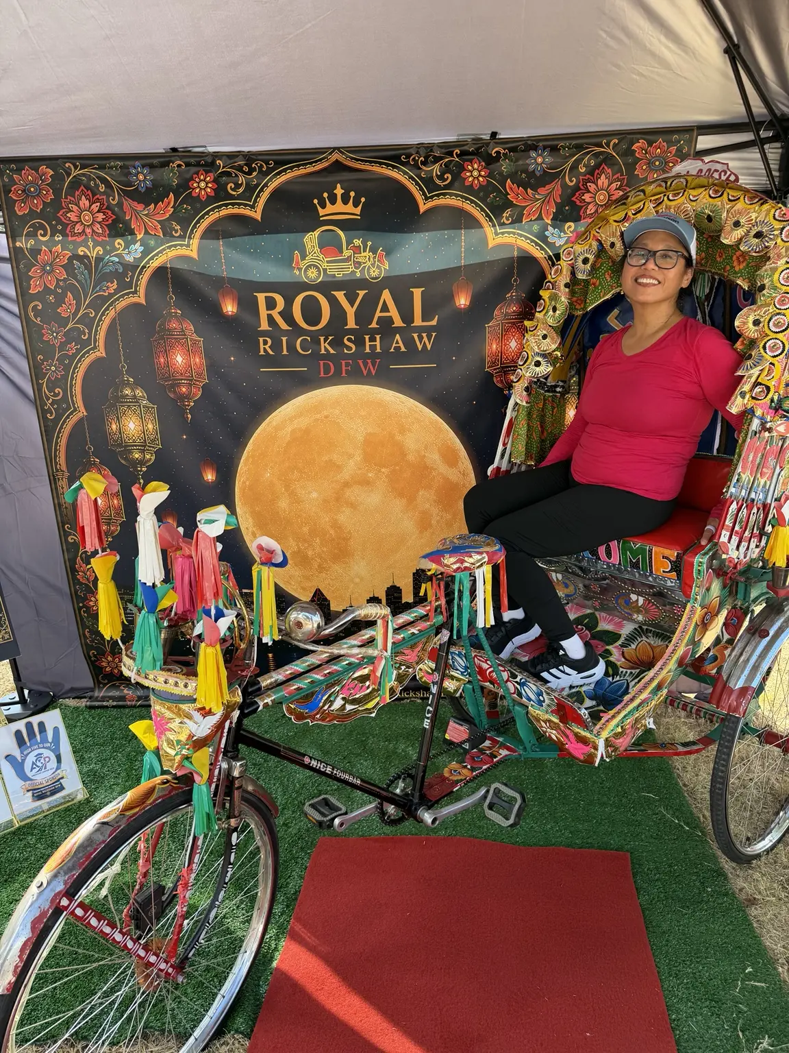 Guest seated in the Royal Rickshaw beneath its ornate hand-painted canopy