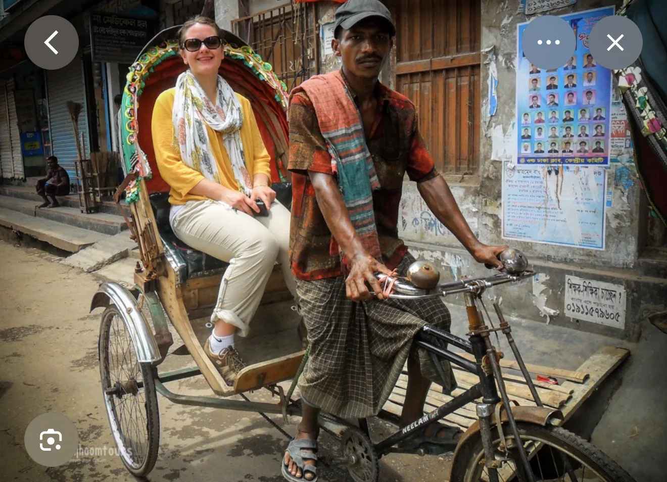 Reference image of a visitor riding in a Bangladesh rickshaw