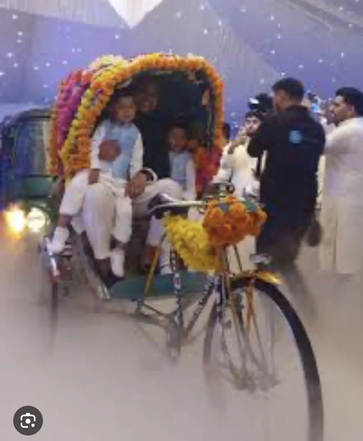 Reference event image showing guests seated in a flower-decorated rickshaw