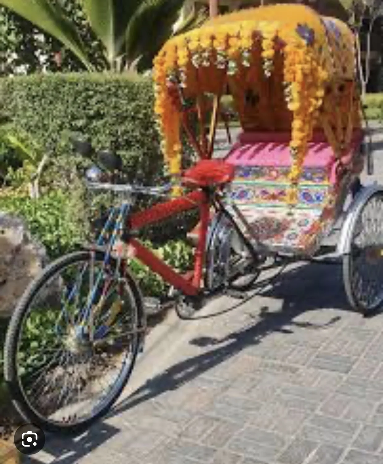 Reference image of a rickshaw decorated with marigold flowers
