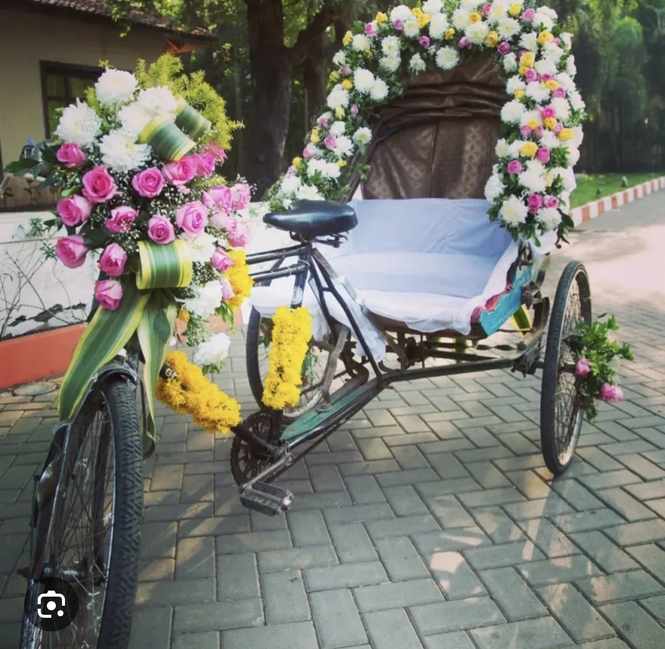 Reference image of a flower-decorated rickshaw for a special event