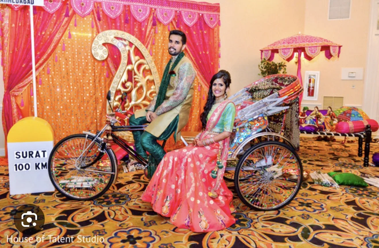 Reference wedding image of a couple posed with a rickshaw